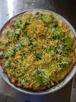 The Twin Bay Resort Twin Bay Mac Pizza, 1000 Island Dressing, Ground Chuck, Diced Onions, Pickles, Lettuce & Cheddar Cheese.